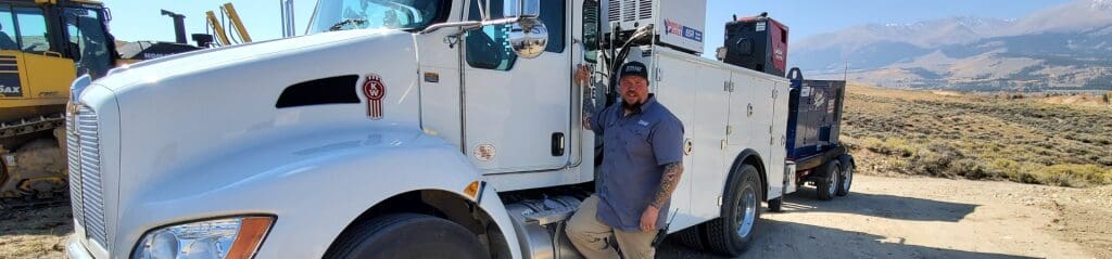 Dave Turin of Gold Rush posing next to his TMAX Aluminum Mechanic Truck