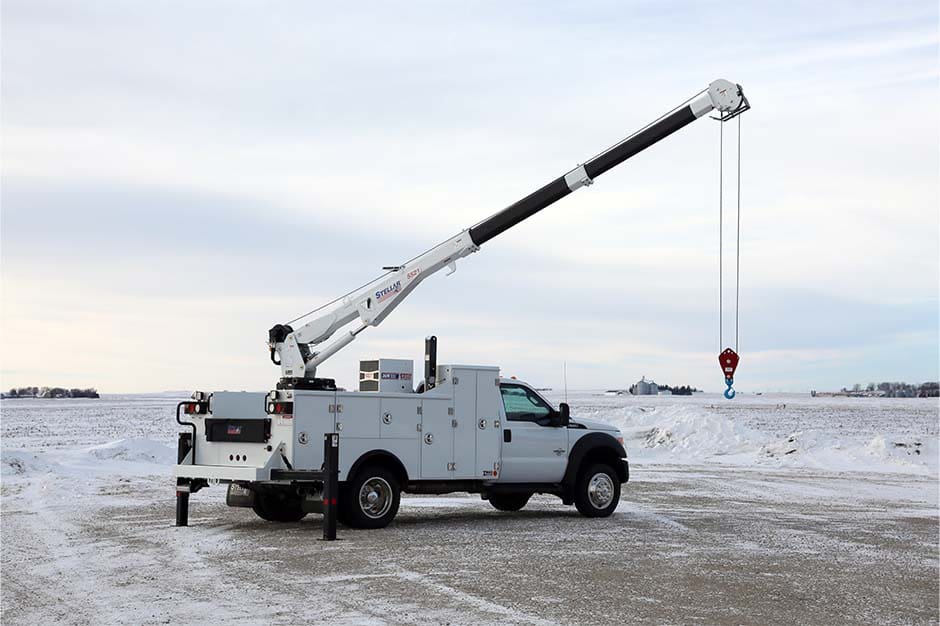 A white TMAX 30K with a crane extended overhead