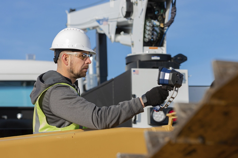 Male worker using rangefinder