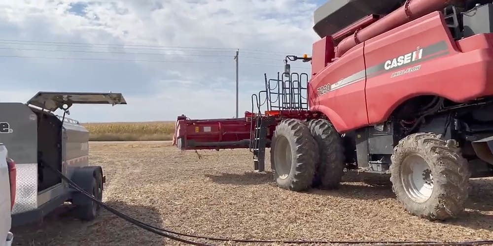 Fuel trailer next to large farm equipment