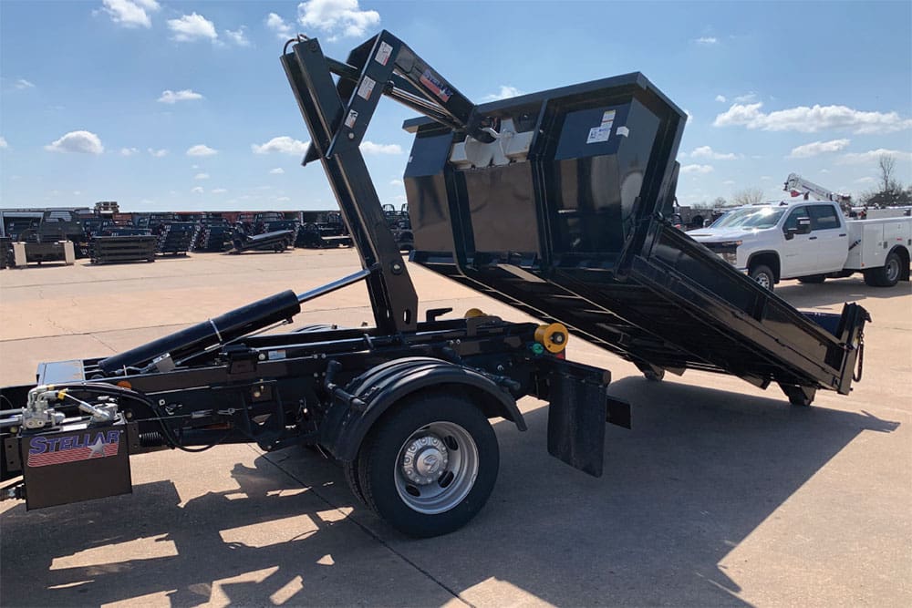 Cable hoist container hooklift adapter kit being used on a service truck