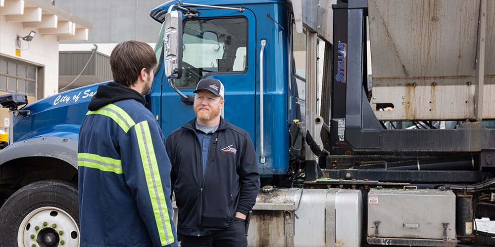 Stellar distributors talking in front of a blue truck