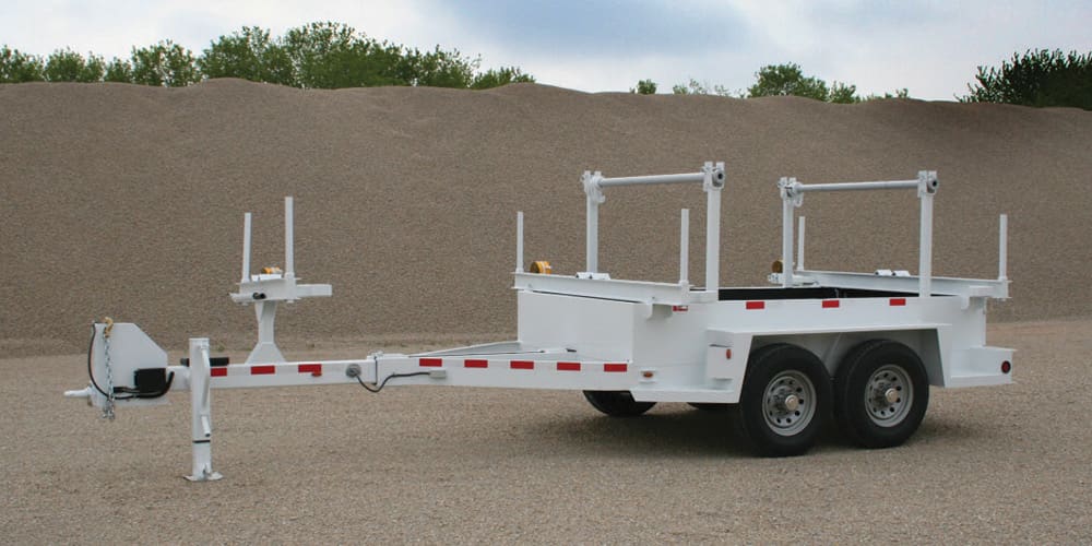 ICP Utility Pole Trailer parked in front of a mound of sand