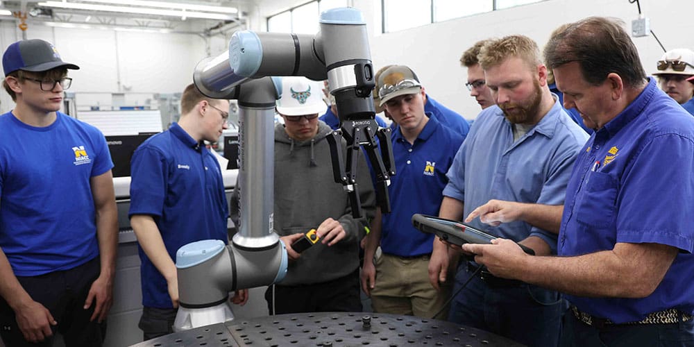NIACC Robotics Program students and staff using their new UR10 Collaborative Robot