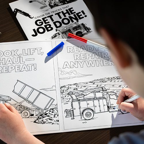 Child coloring a truck in the Stellar coloring book.