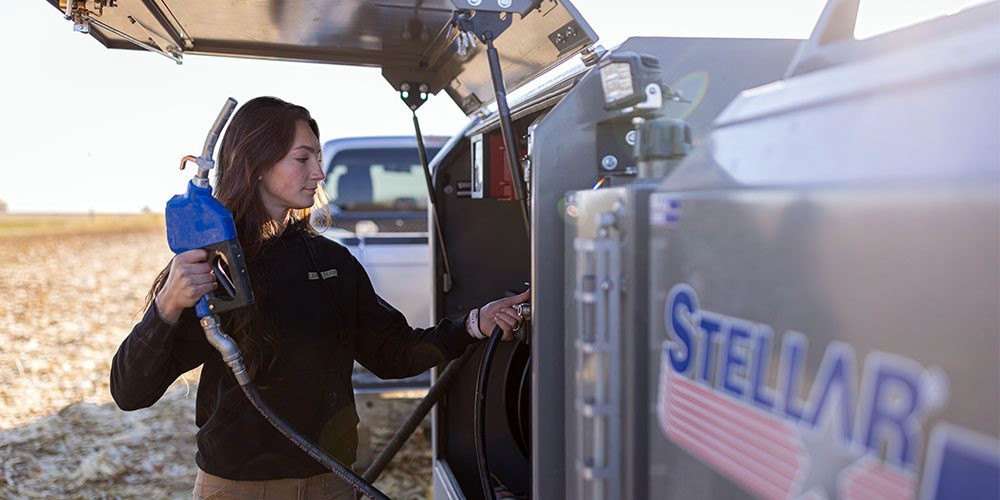 Laura from Laura Farms operating her fuel truck in a field.