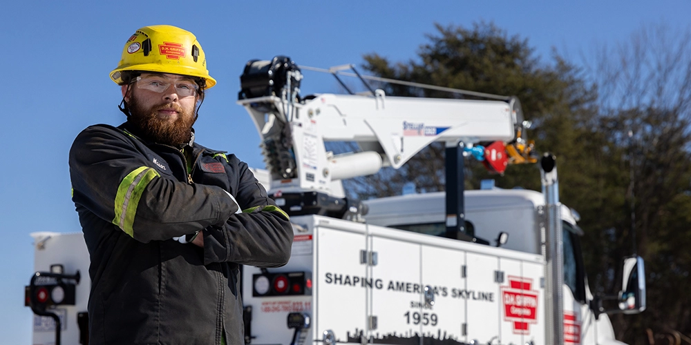 DH Griffin employee standing in front of a TMAX2 with a 12621 crane