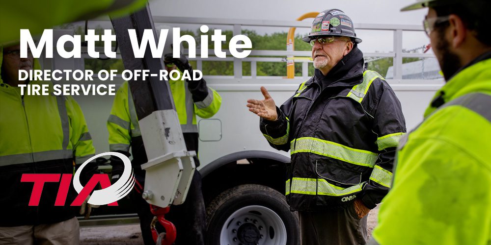 Matt White, TIA Director of Off-Road Tire Service, speaks with crew members in front of a Stellar tire service truck.