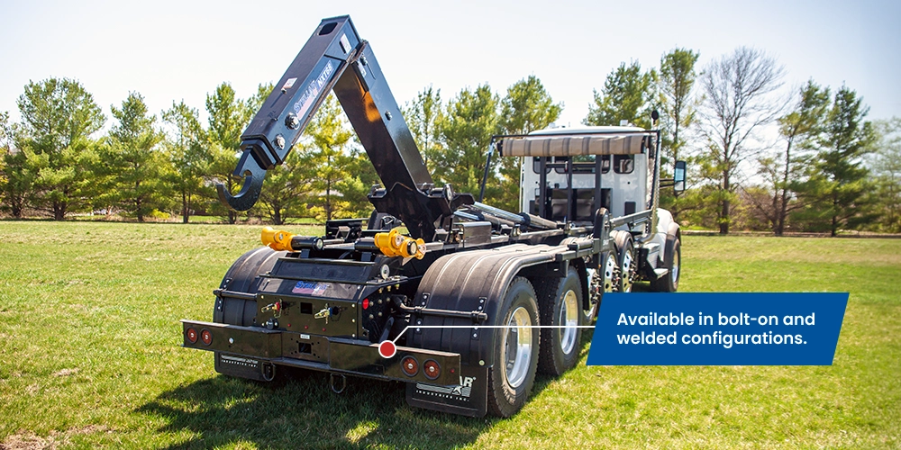 Rear view of a black Stellar NXT hooklift, highlighting the rear bumper with text reading "Available in bolt-on and welded configurations."
